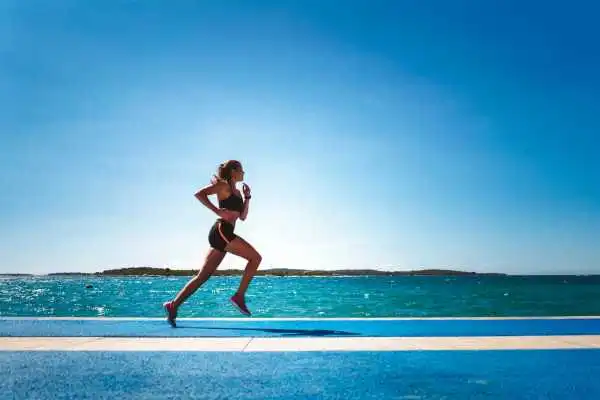 Woman running showing strong leg muscle Chippenham